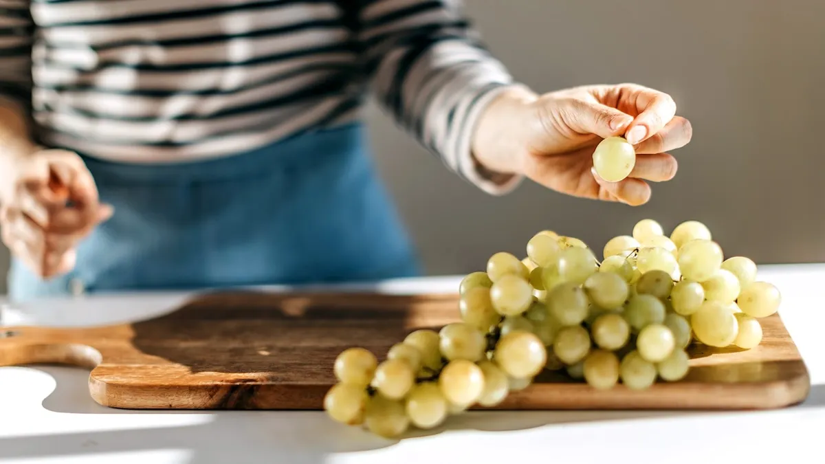Woman enjoying grapes